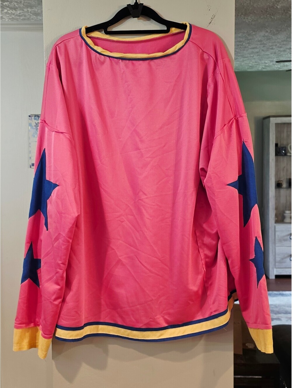 Pink long sleeve top with blue stars and striped trim